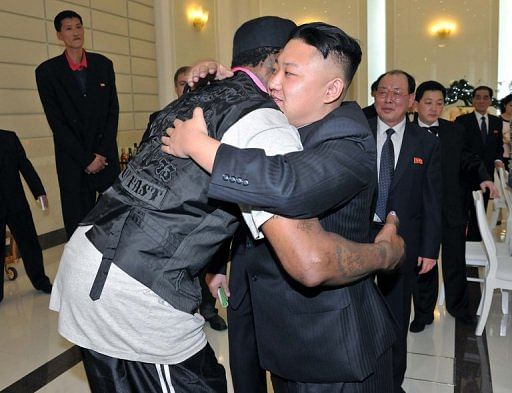 Kim Jong-Un (right) hugs Dennis Rodman (left) at a dinner in Pyongyang on February 28, 2013